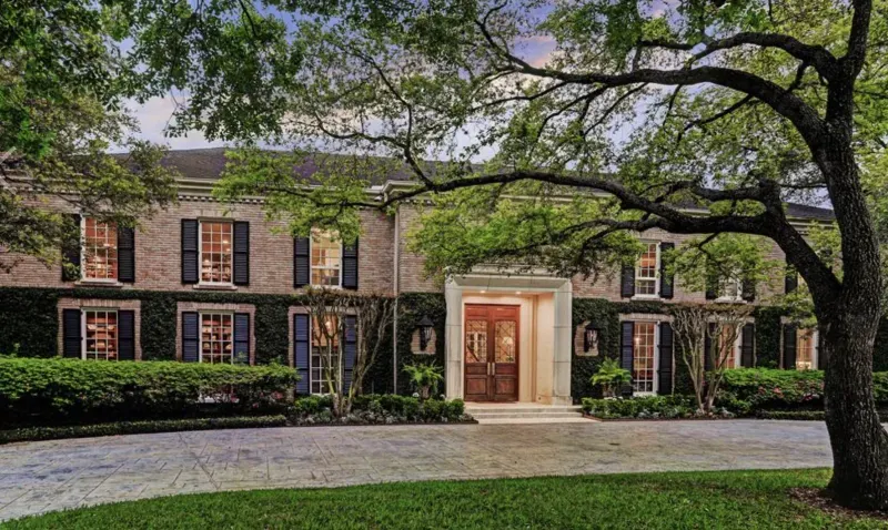 Ivy-covered brick estate exterior at dusk