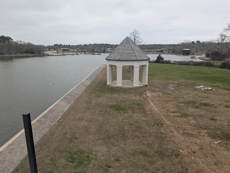 Finished white gazebo on lakeside dock