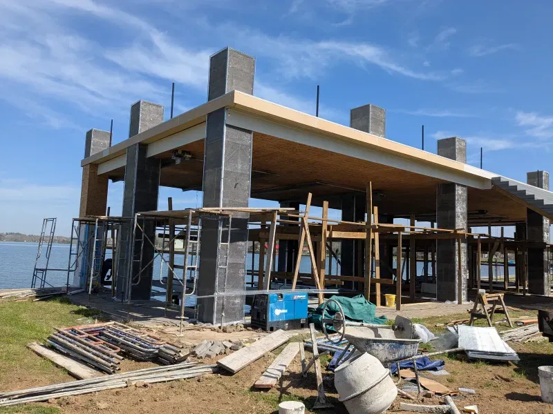 Lakeside pavilion structure with steel framing under construction