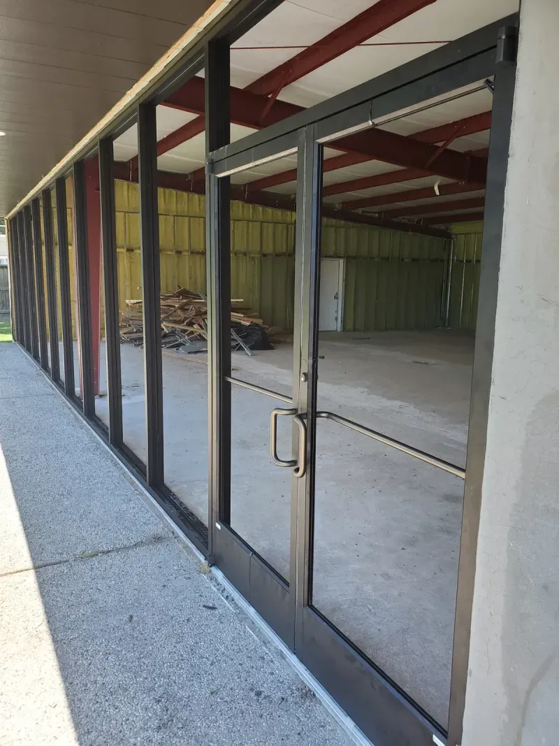 Glass storefront framing under construction at commercial building