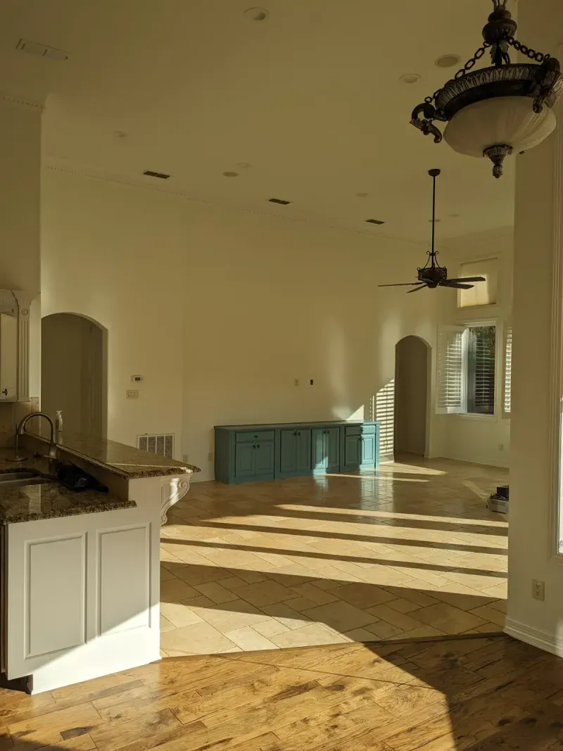 Open-concept kitchen and living area with wood and tile flooring
