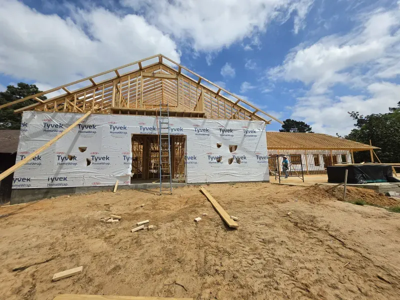 New estate home framing with roof trusses and house wrap