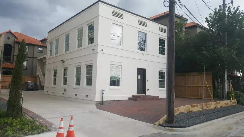 White stucco commercial building exterior with paved courtyard
