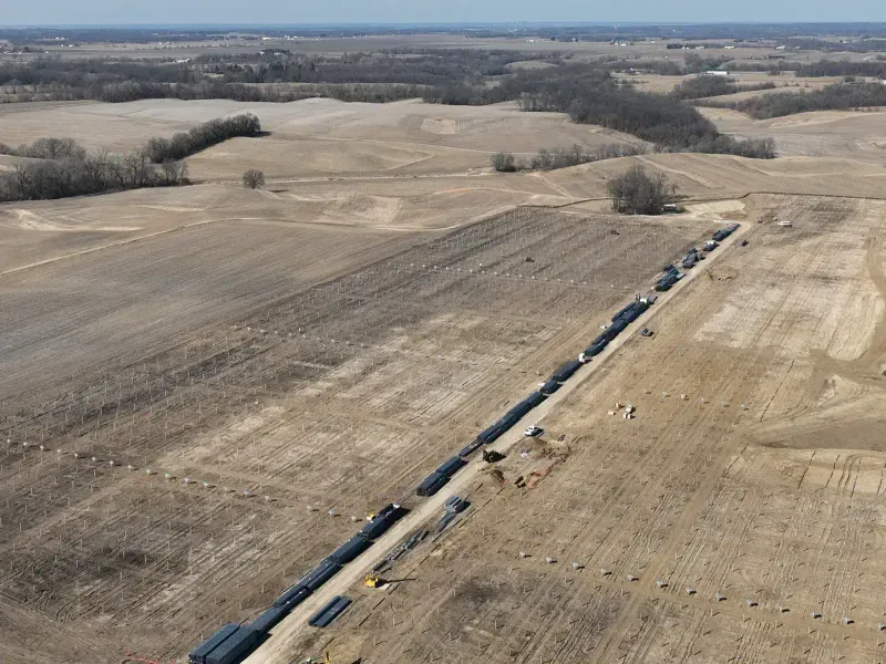 Aerial view of panel rows and equipment staging along access road