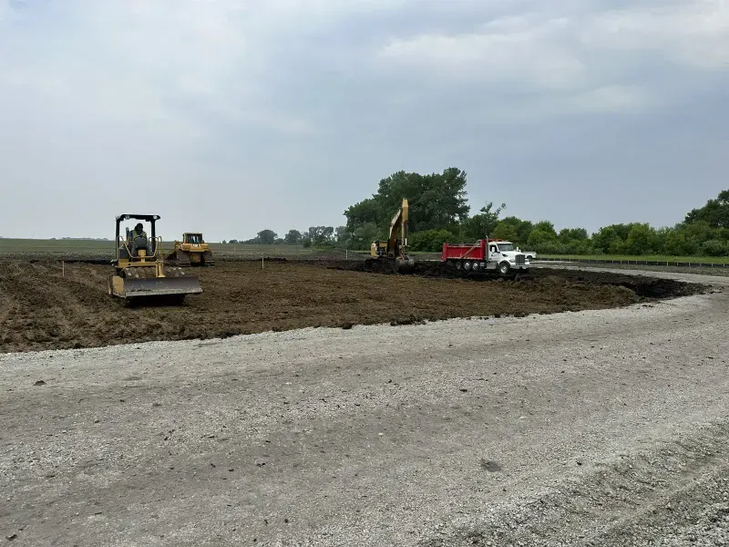 Site grading with bulldozer, excavator, and dump truck