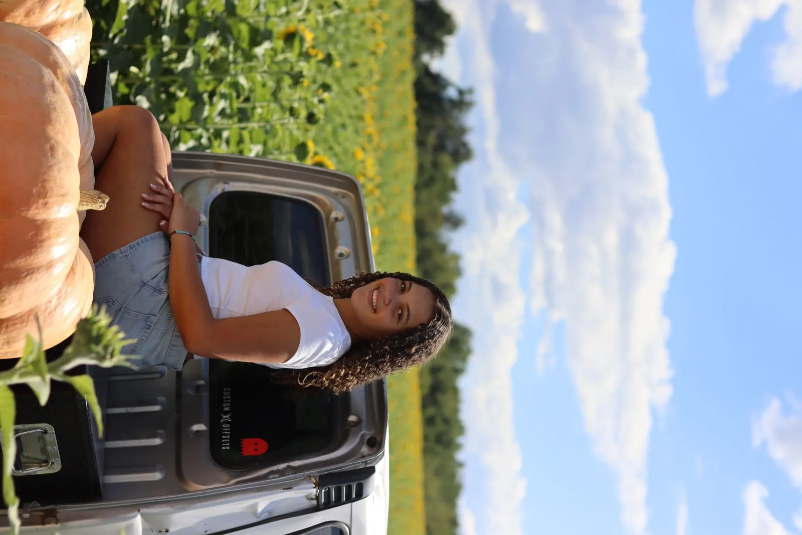 Lifestyle portrait near a sunflower field photographed by CarlyArchive