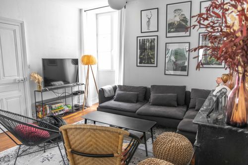The lounge TV area with grey sofa and decorative fireplace