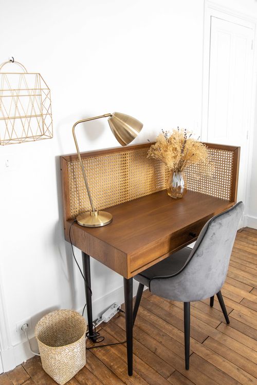 The small wooden desk and chair in the first bedroom