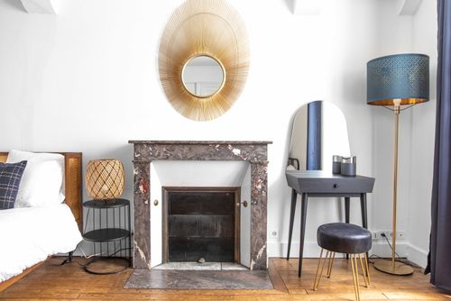 The marble fireplace and dressing table beside the bed in the first bedroom