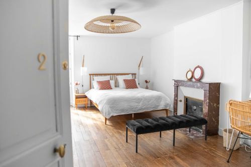 The second large bedroom with a double bed and decorative fireplace