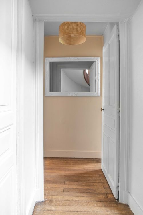 The upstairs corridor with parquet and white doors