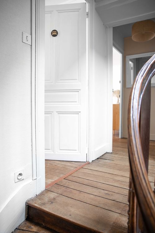 The parquet landing and bedroom doors at the top of the stairs
