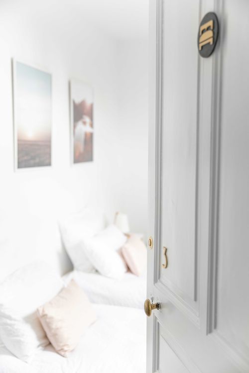 The pastel bedroom with single beds, viewed from the doorway