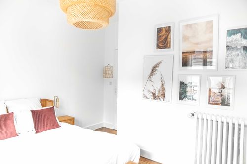 The double bed and nature illustrations in the fifth bedroom