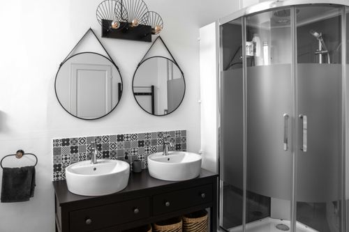 The two basins and mirrors beside the shower cubicle