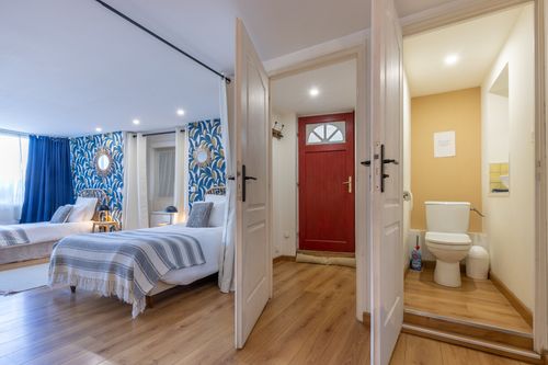 The passage between La Chambrée’s sleeping area, red entrance door and toilet