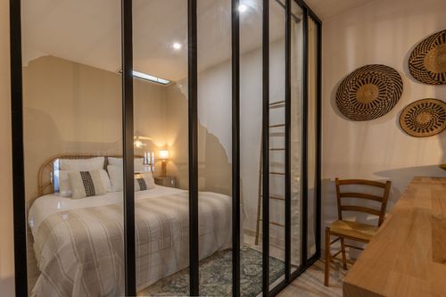 La Chambrée’s double bedroom behind its black-framed glass partition