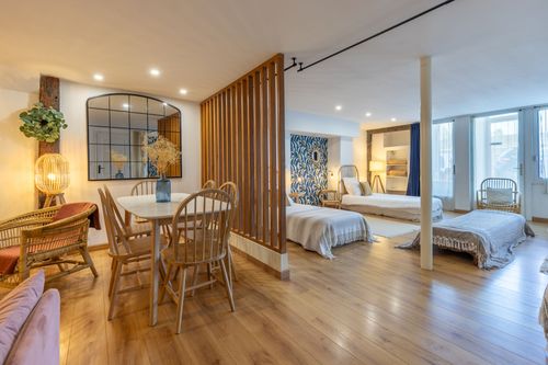 La Chambrée’s dining area and wooden partition beside the beds