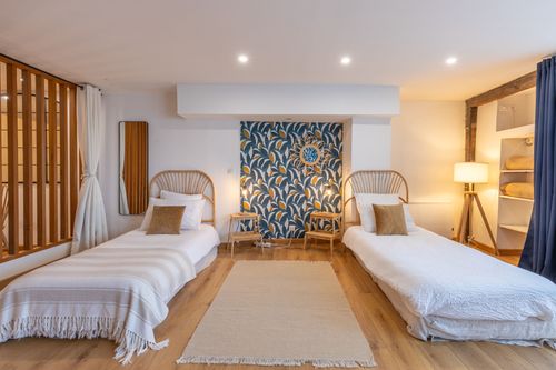 La Chambrée’s single beds with rattan headboards and leafy decorations