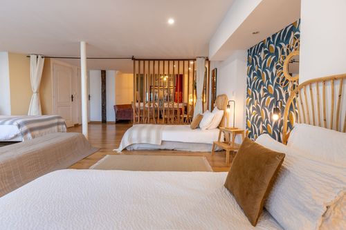 La Chambrée’s beds separated from the lounge by a wooden screen