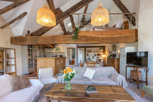 Le Loft’s lounge and open mezzanine beneath the roof timbers