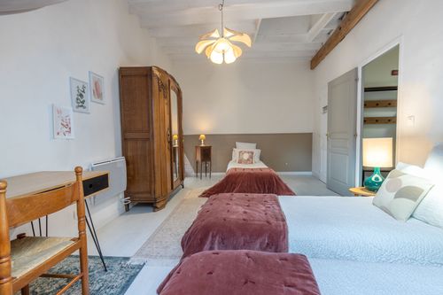 The single beds, desk and old wardrobe in Le Loft’s bedroom