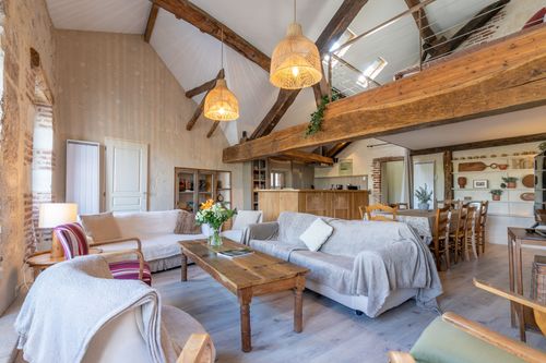 Le Loft’s sofas beneath the mezzanine, facing the wooden coffee table