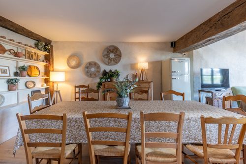 Le Loft’s dining table in front of the sideboard and shelves