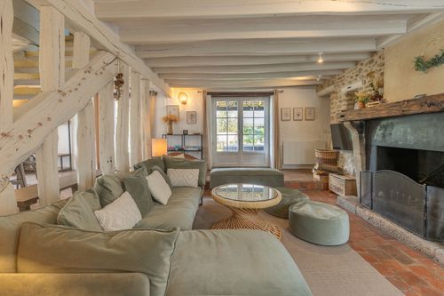 The lounge corner sofa facing the large stone fireplace