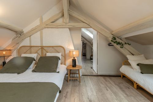 A family bedroom beneath the beams