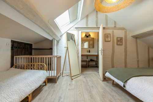 The attic family bedroom with a double bed, single bed and cot