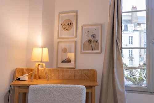 The bedroom desk area beside the window