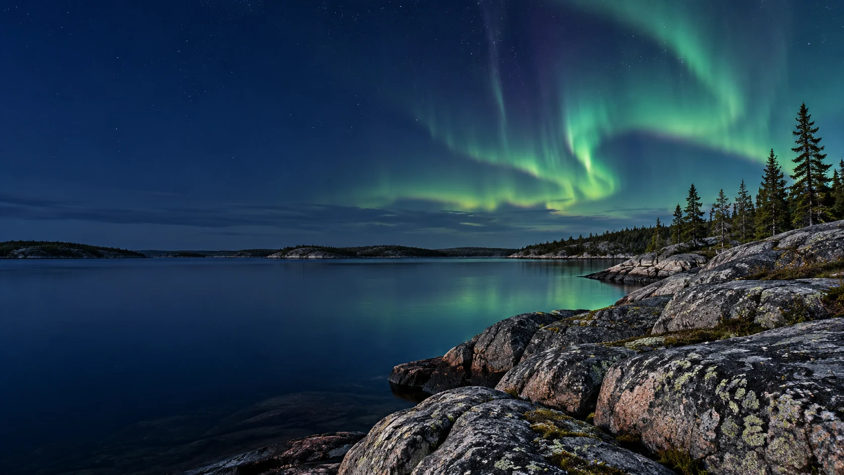 Northern lights above a rocky northern lake