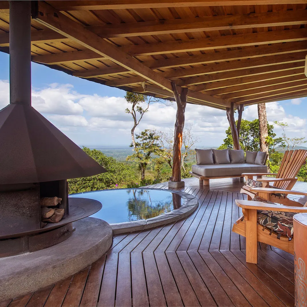 Lodge terrace with a plunge pool and fireplace in Costa Rica