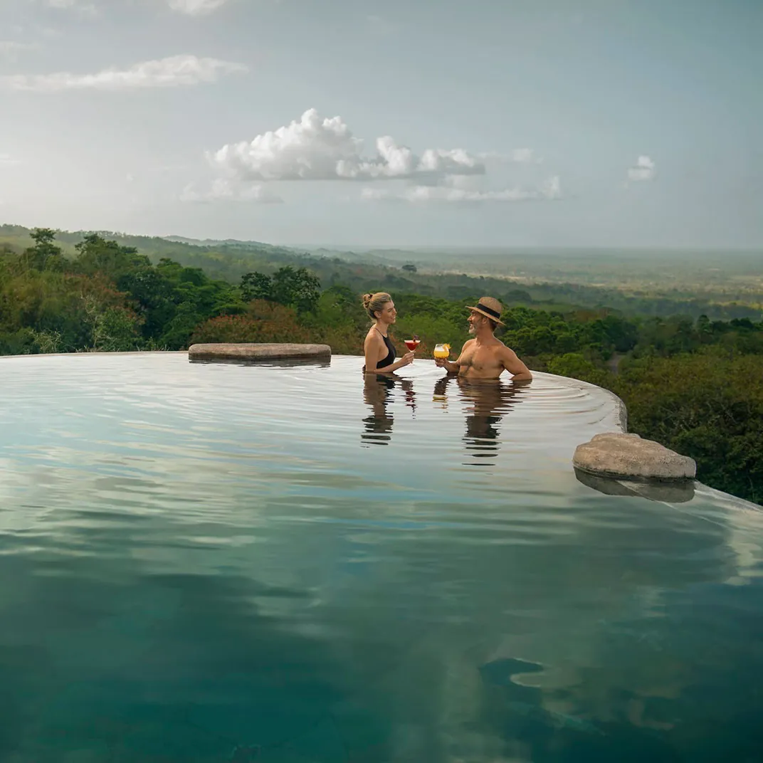 Couple in an infinity pool overlooking the jungle in Costa Rica