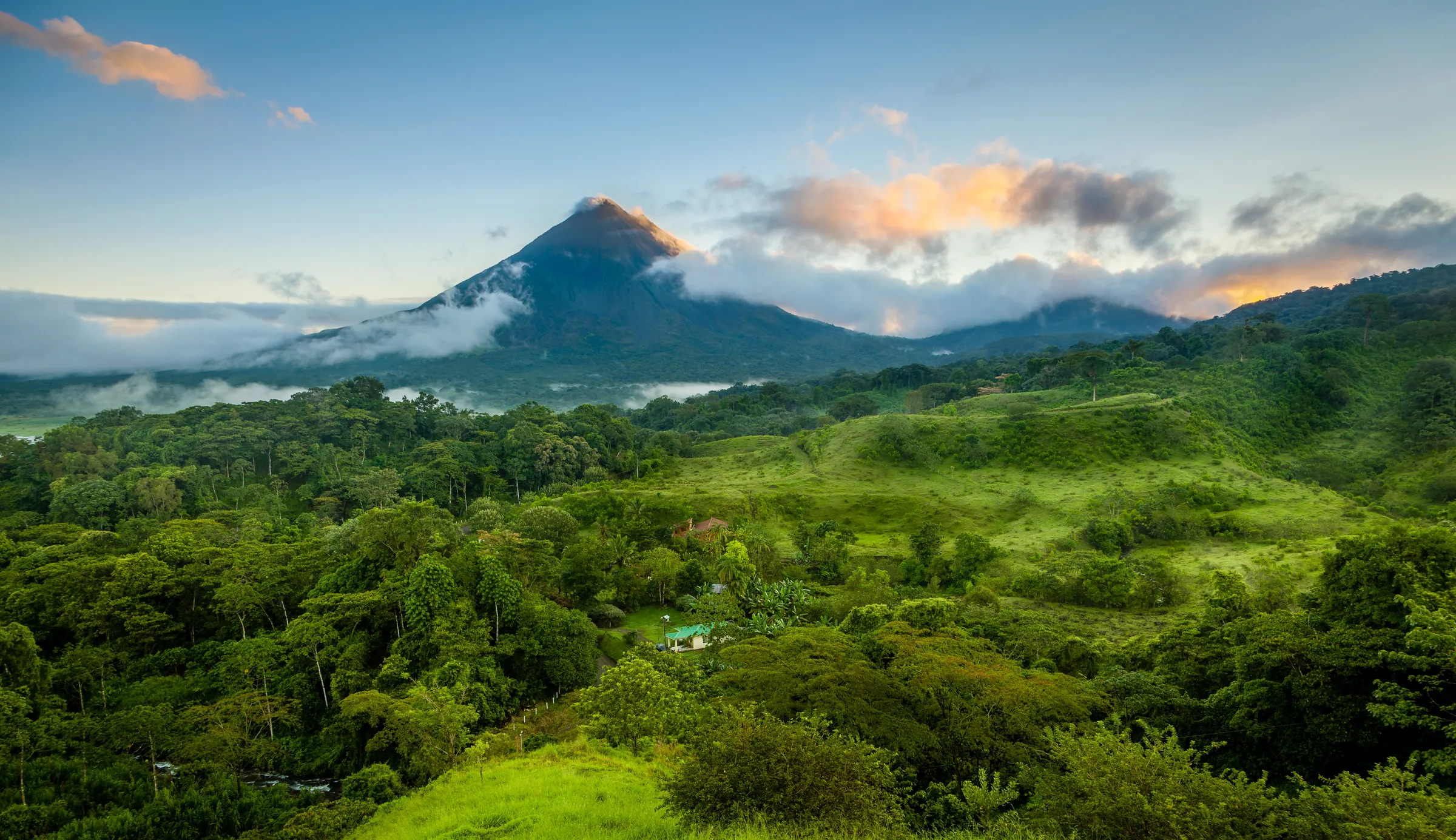 Arenal Volcano rising beyond green hills, Costa Rica