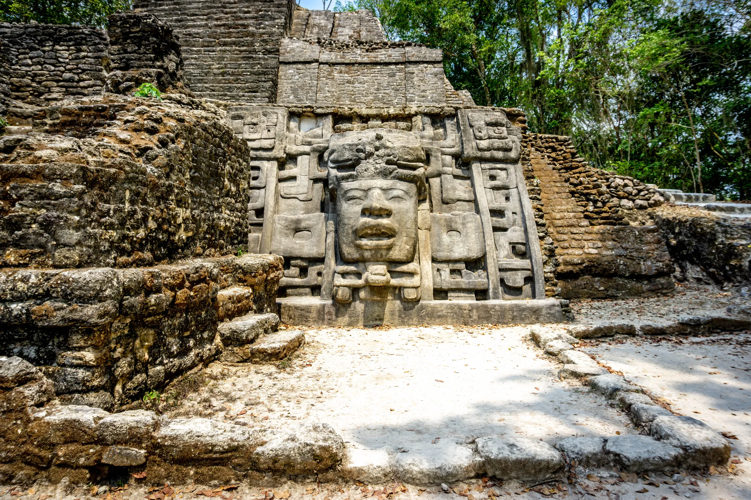 Carved stone mask at Lamanai's Mask Temple, Belize