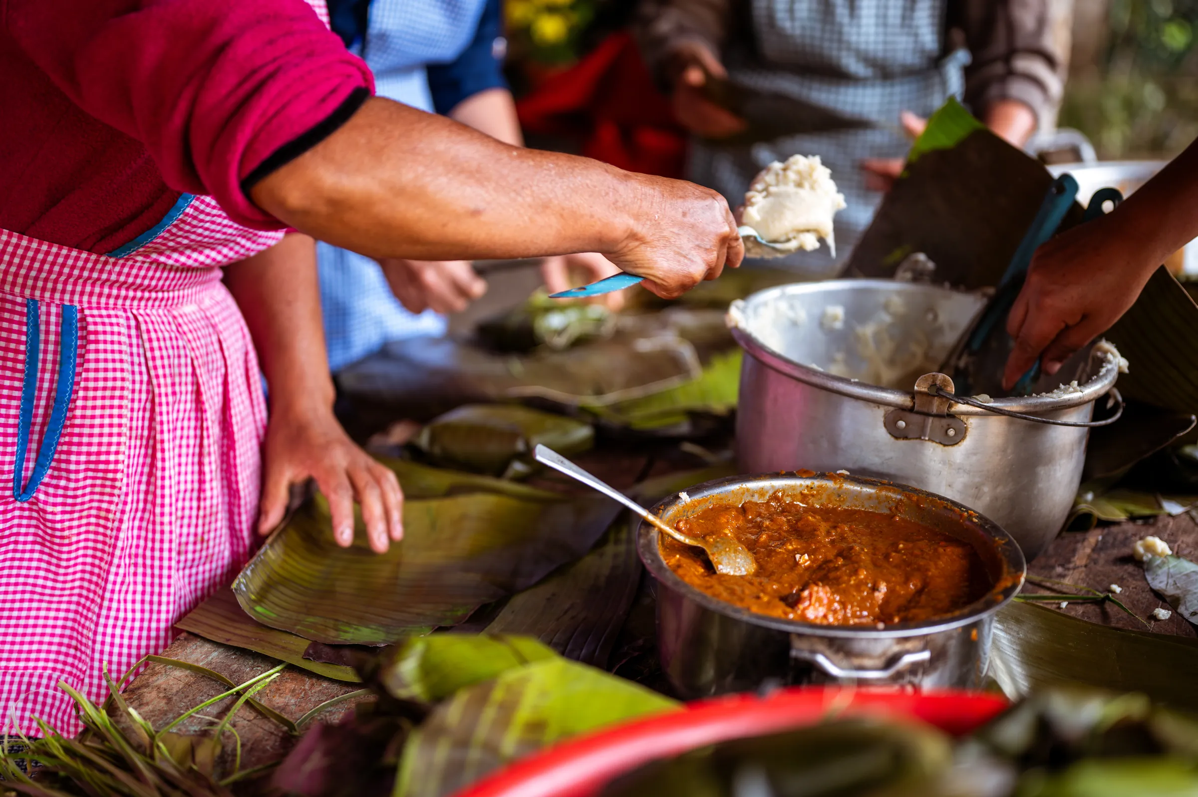 Maya women cooking a traditional stew, Guatemala