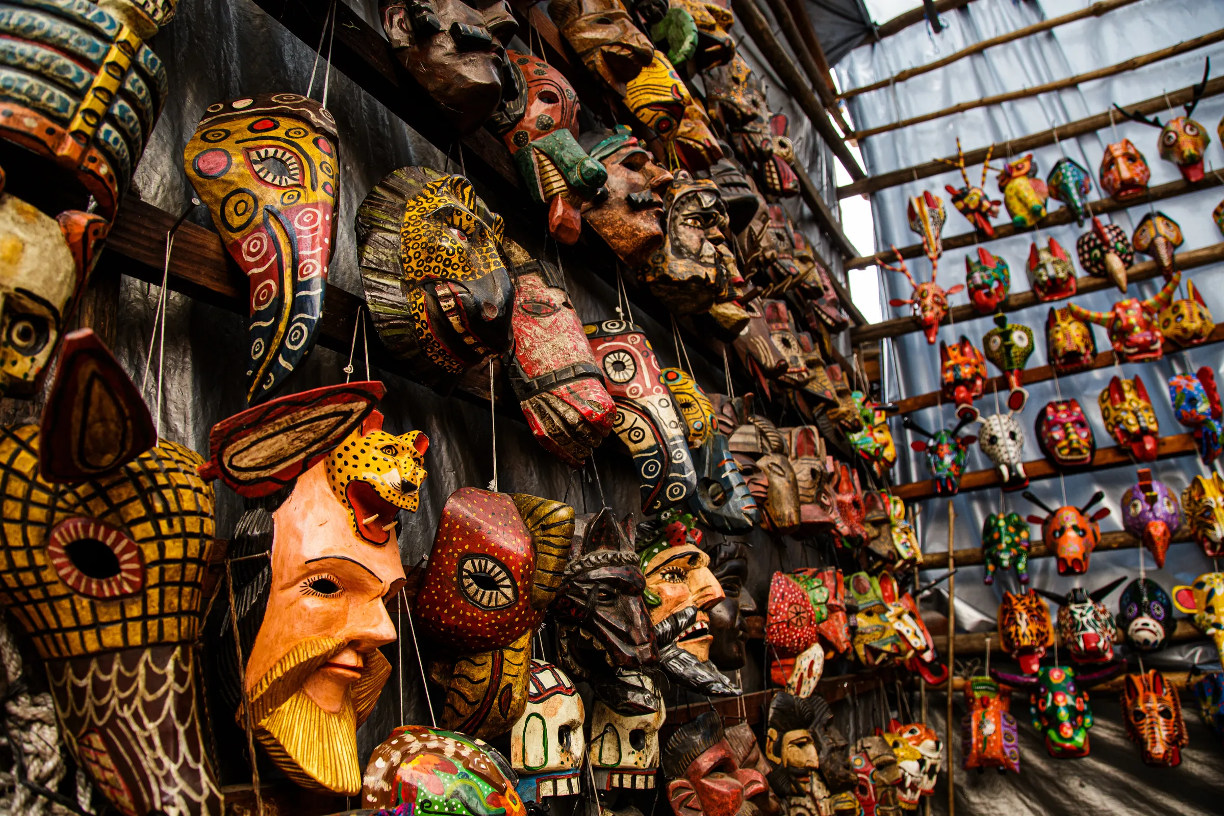 Carved wooden masks for sale at a Guatemalan market