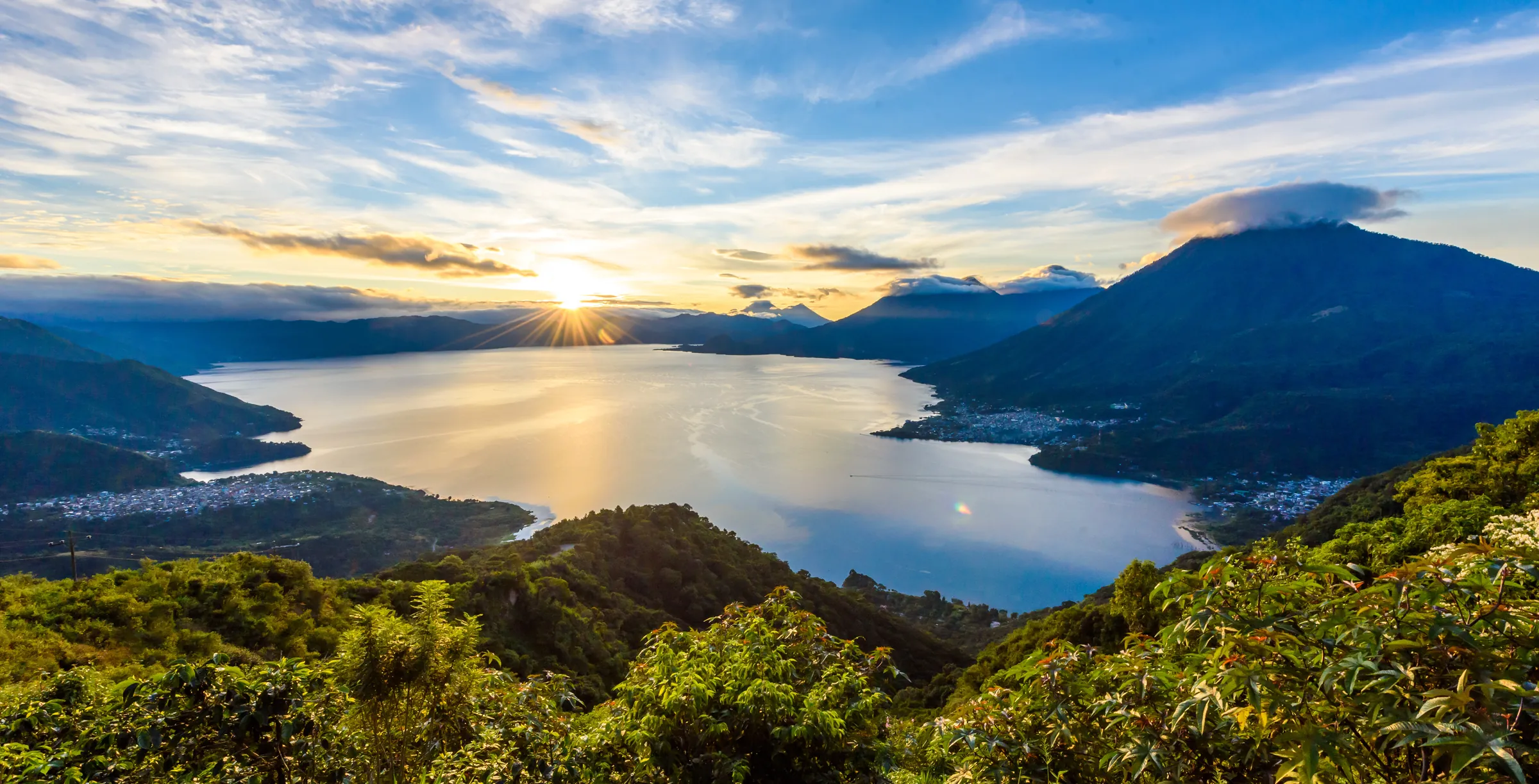 Sunrise over Lake Atitlán and its volcanoes from a lookout