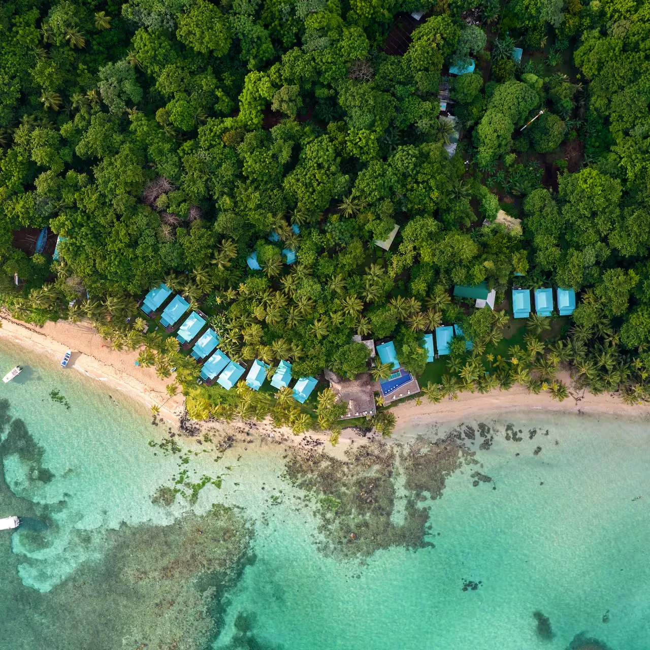 Aerial view of beachfront cabanas beside the reef on a Caribbean island, Nicaragua