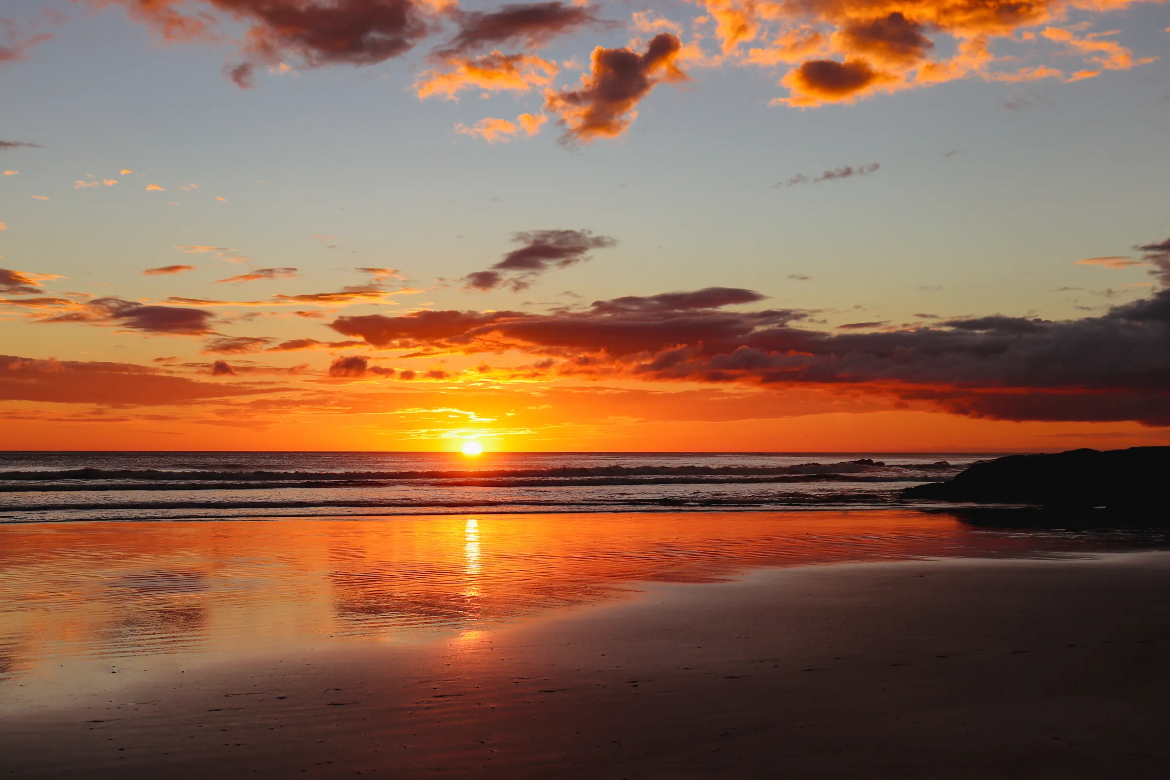 Fiery sunset reflected on a Pacific beach, Nicaragua
