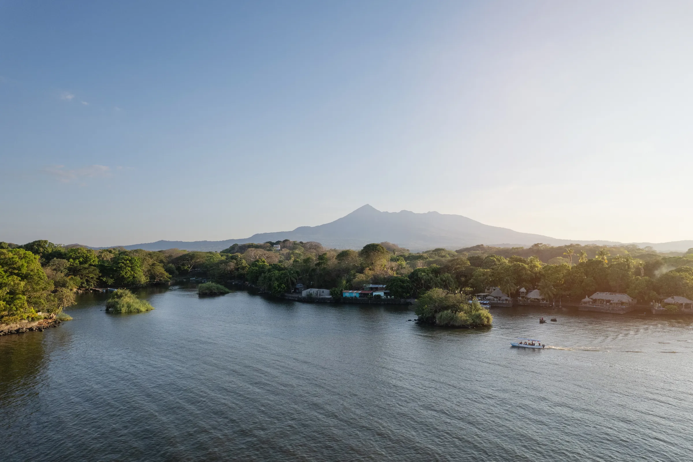 Small boat among the Isletas with Mombacho Volcano behind