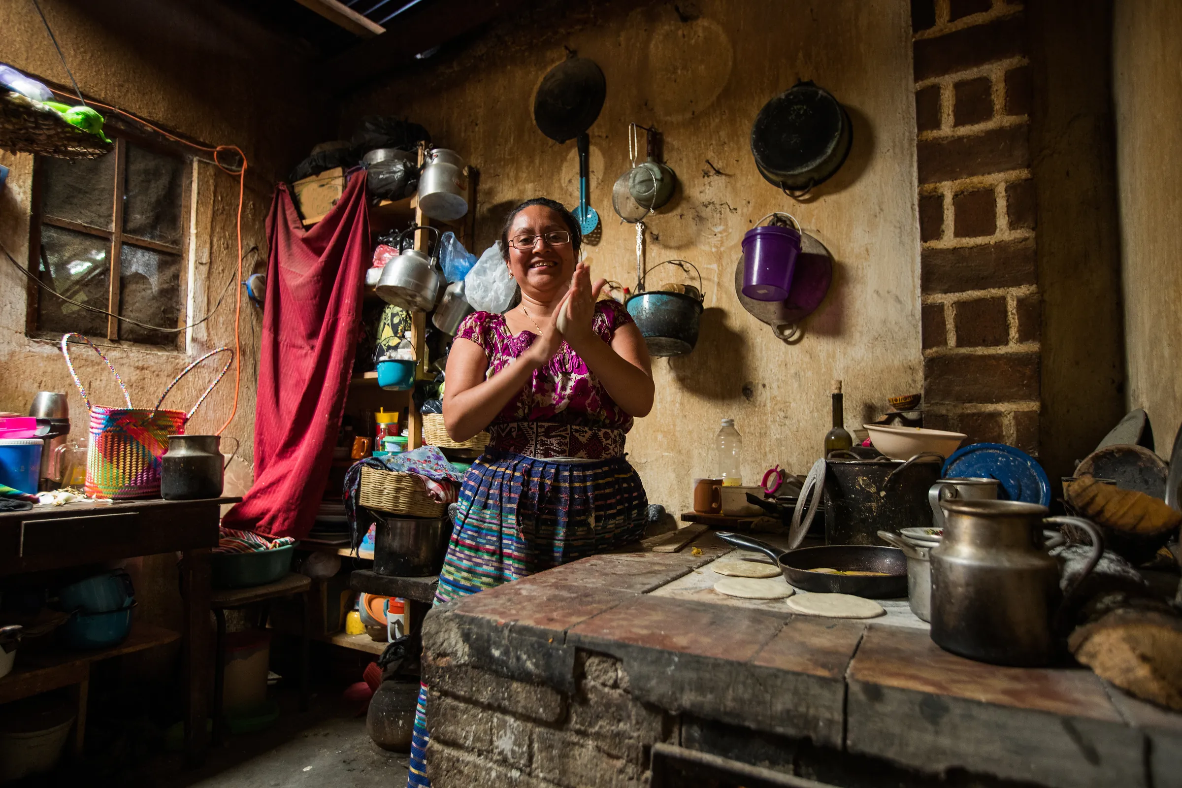 Woman pressing tortillas by hand, Guatemala