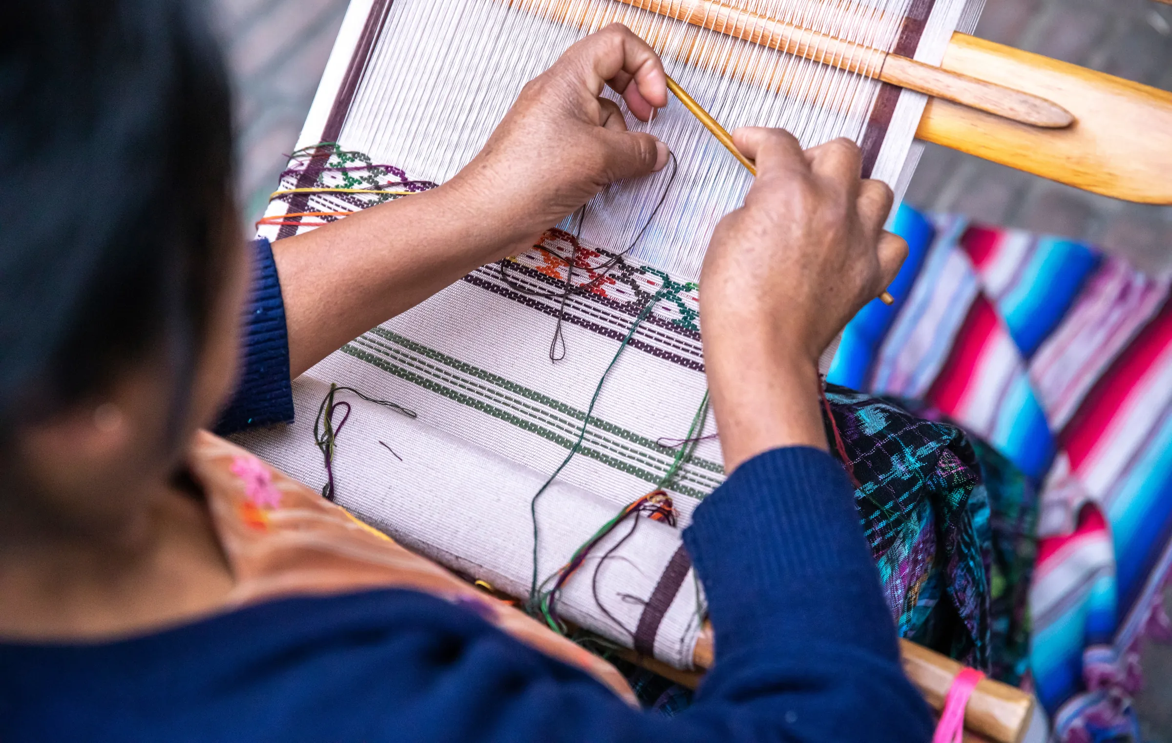 Hands weaving on a backstrap loom, Guatemala