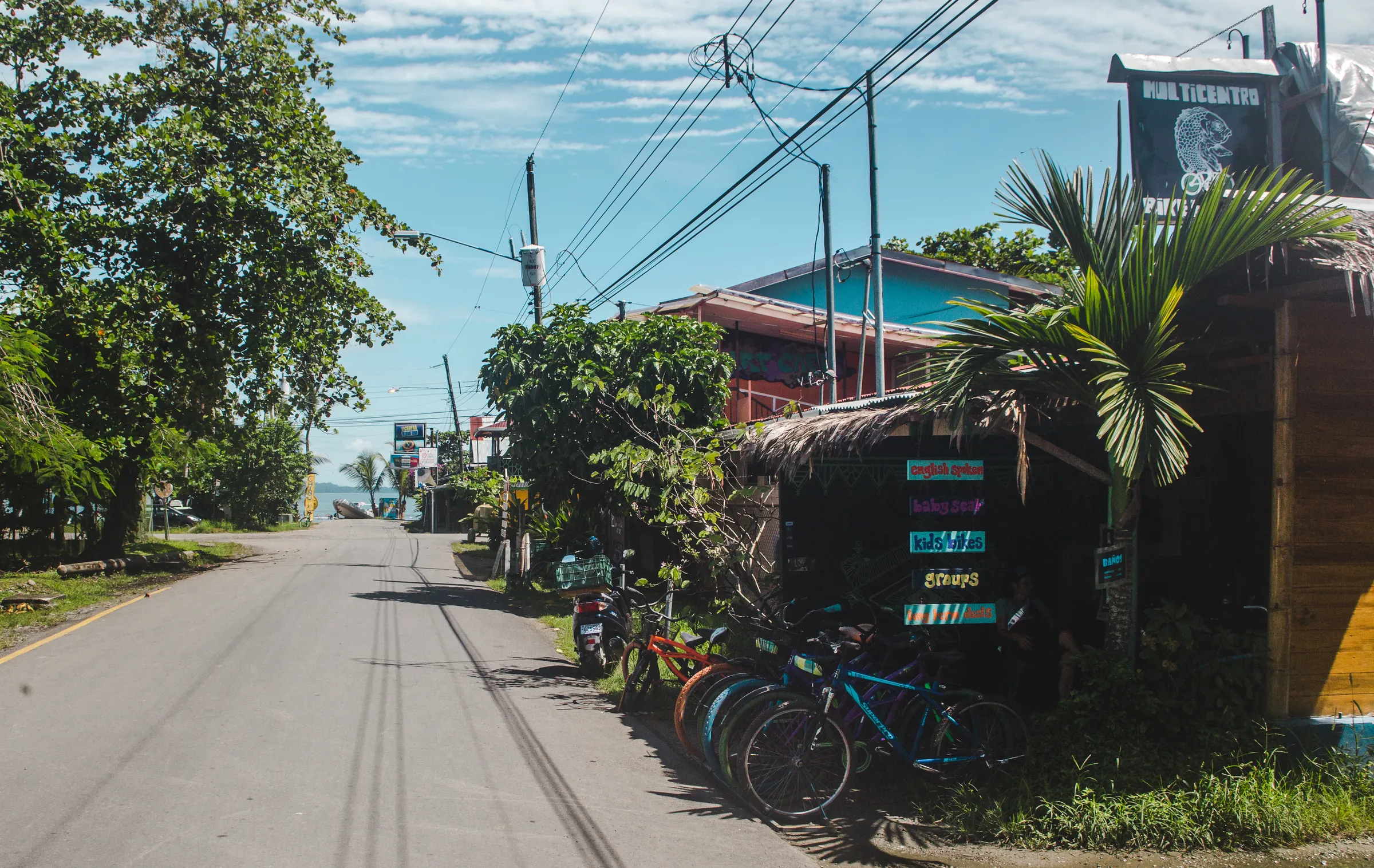 Bicycles beside buildings on a quiet coastal street