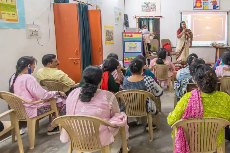 Teachers seated in a room during a Pinkishe menstrual health training, a trainer at the front