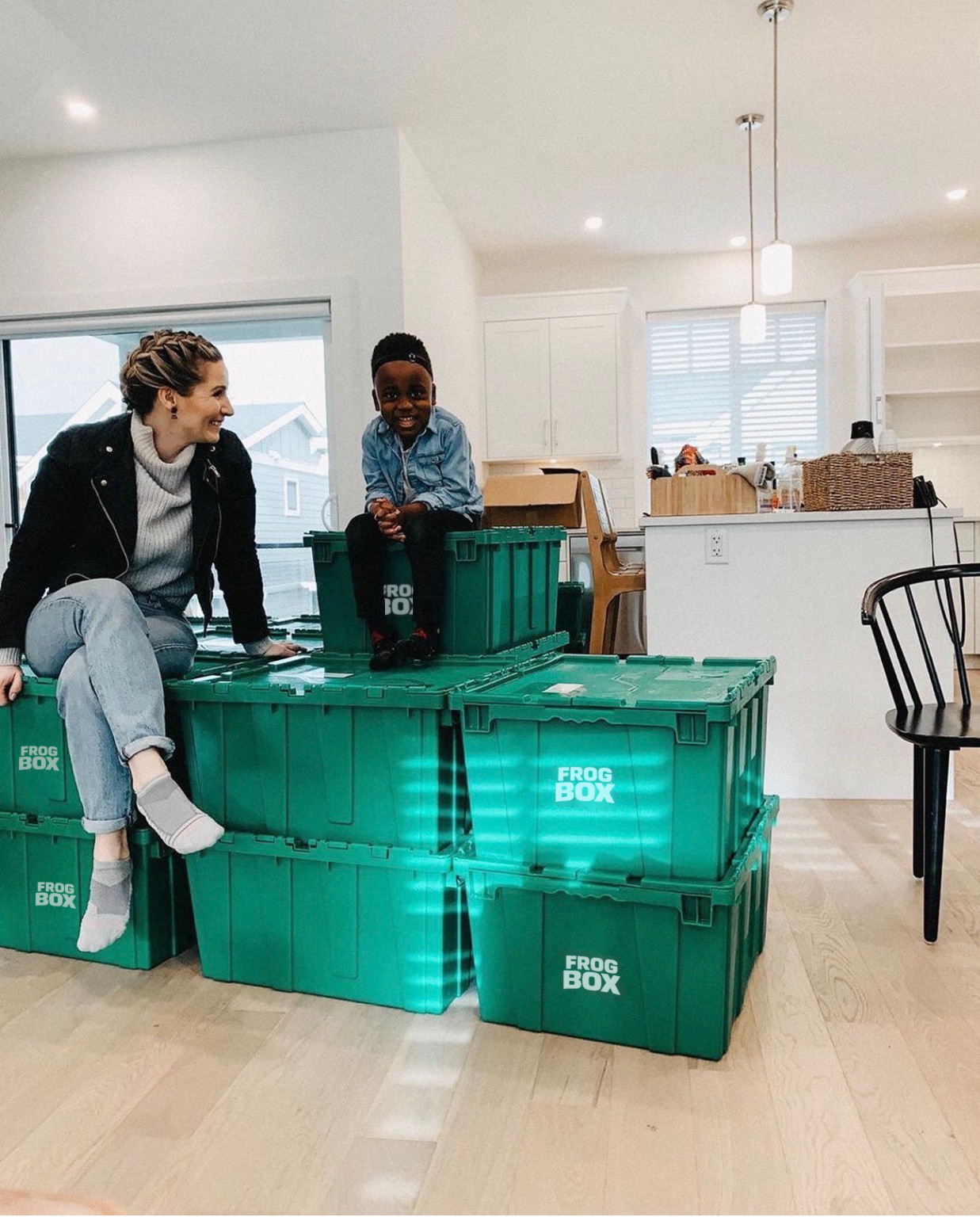 A candid family moment beside green Frogbox bins at home