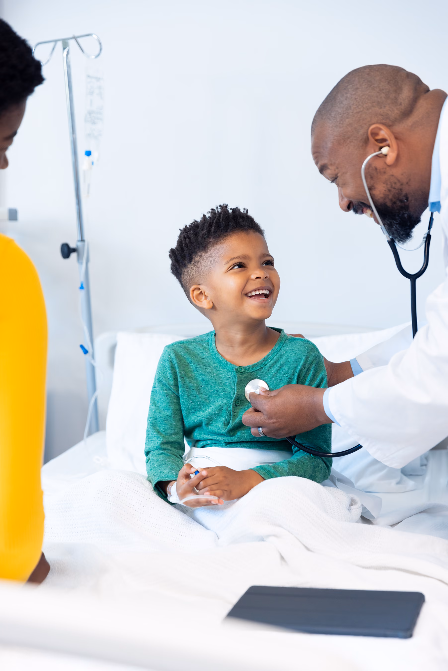 Doctor checking a smiling child's heartbeat