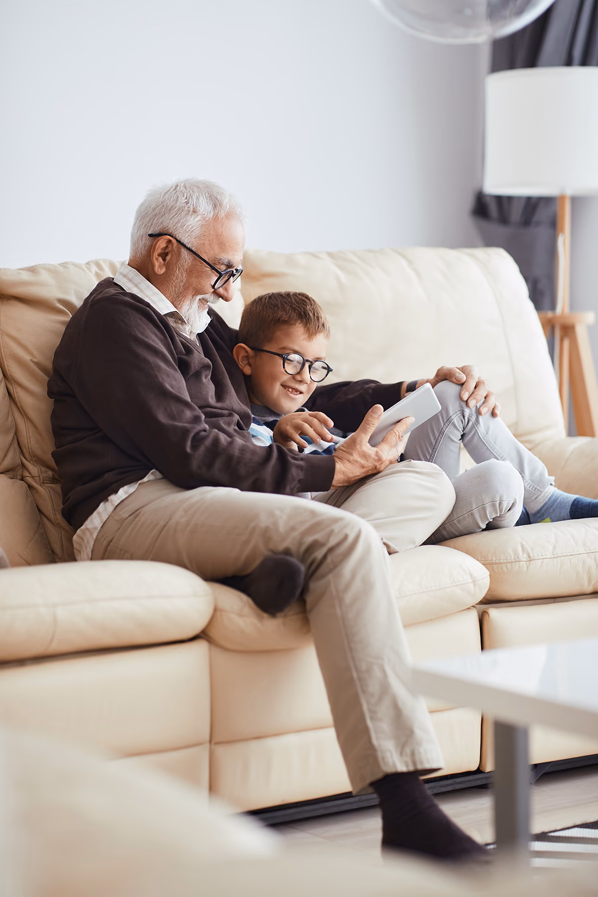 Grandfather and grandson looking at a tablet